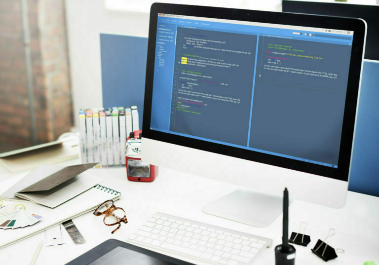 a computer monitor on a desk