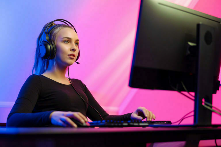 a person wearing headphones and sitting at a computer