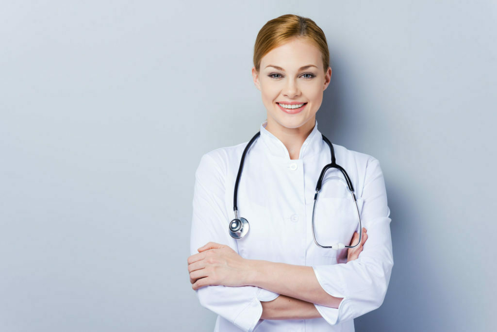a doctor smiling with her arms crossed