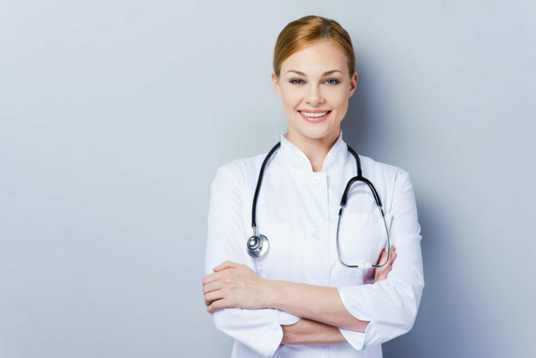 a doctor smiling with her arms crossed