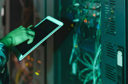 Male informatic engineer working inside server room database